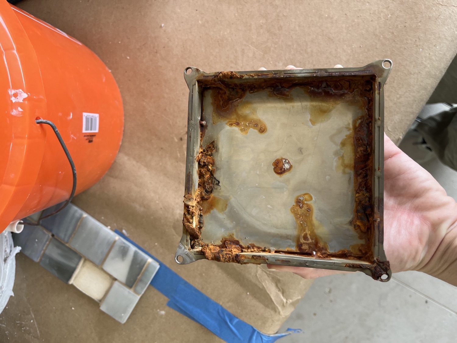 Rust on the underside and edges of the original stainless-steel pool return grate